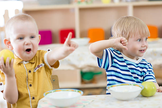istock Funny smiling kids feeding in kindergarten 530193908
