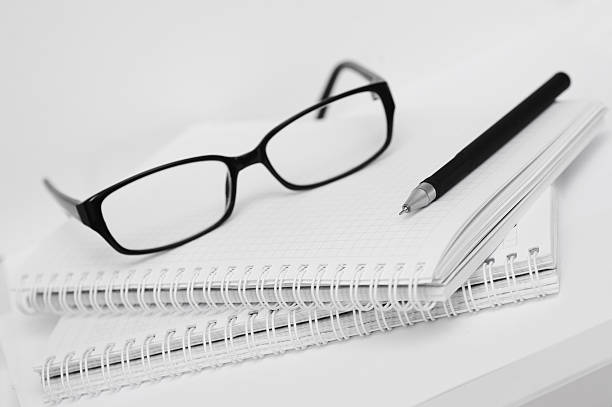 istock glasses and pen on white notebook in cell 530193986