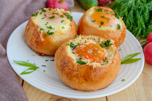 istock Eggs baked in a bun with ham, cheese and herbs 530194080