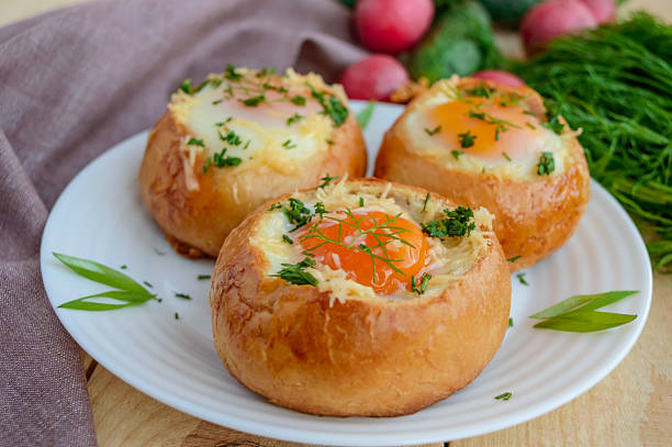 istock Eggs baked in a bun with ham, cheese and herbs. 530194202