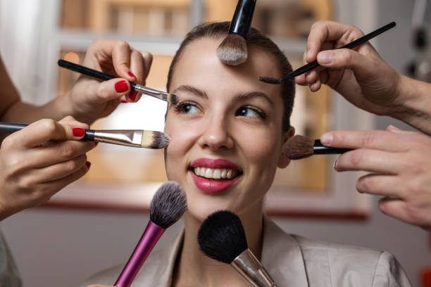 istock Happy woman during beauty treatment with make-up brushes. 530197404