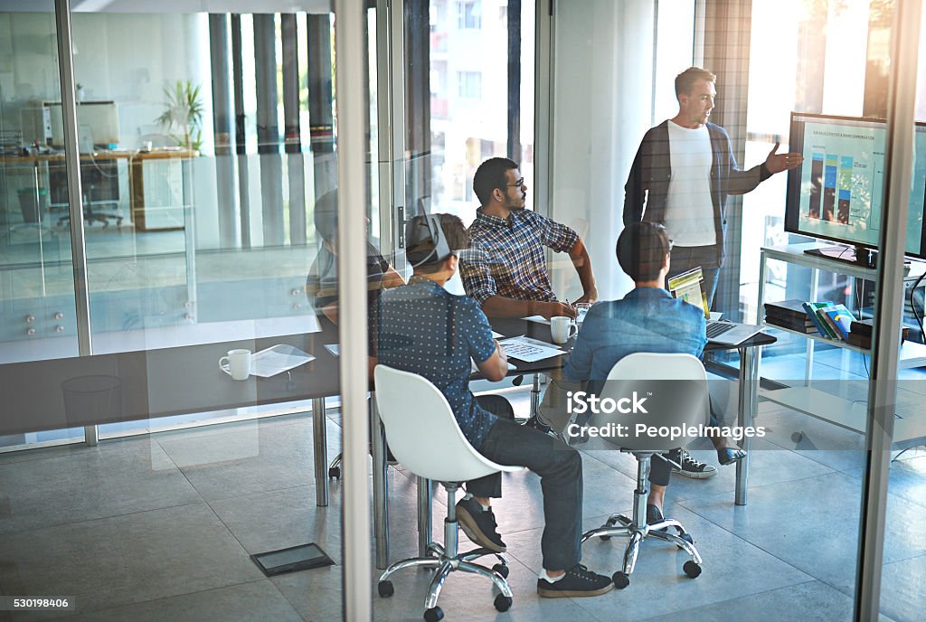 These numbers are strong Shot of a young businessman giving a presentation in the boardroom Technology Stock Photo