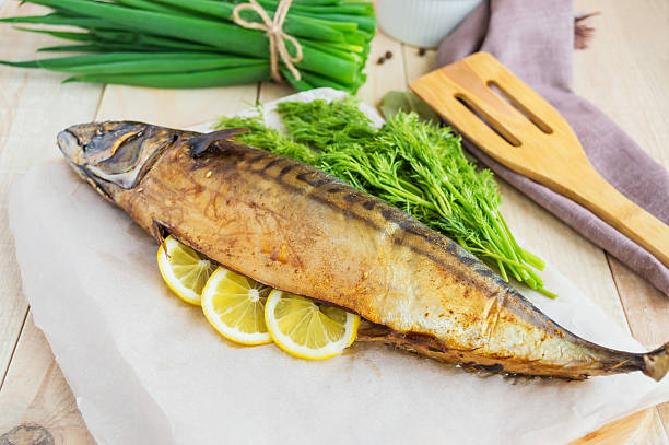 istock Baked sea fish ( mackerel) on wooden background. 530199706