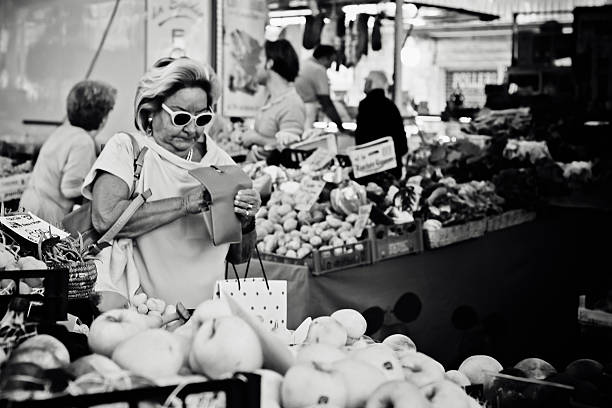 La Spezia, Italy - September 20, 2015: Italian woman checking her wallet at an outdoor market in La Spezia, Italy.