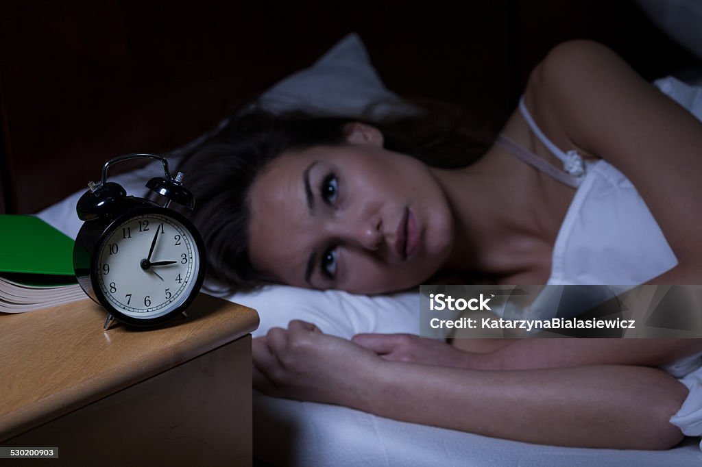 Woman with insomnia Woman with insomnia lying in bed with open eyes Bed - Furniture Stock Photo