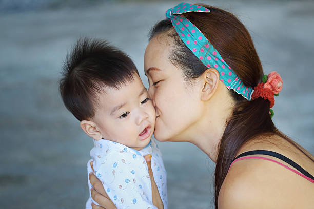 istock Mother kissing her baby 530201353