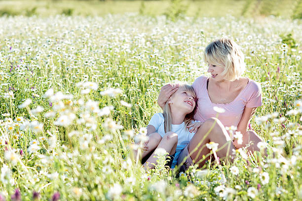 istock mother and daughter walking in a field 530202039