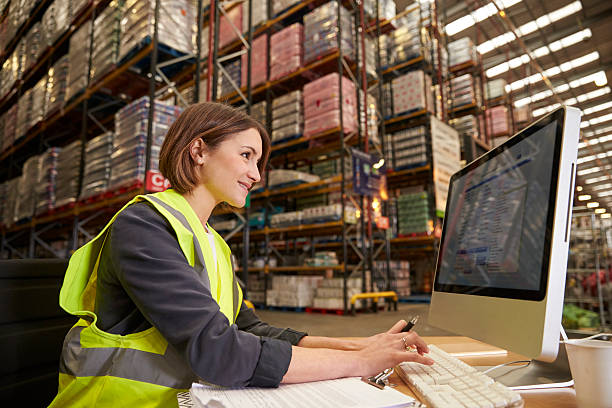 istock Woman working at computer in on-site office of a warehouse 530202742
