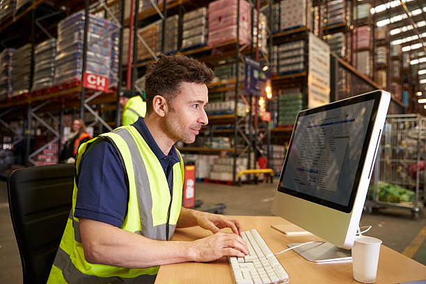 istock Man working in on-site office at a distribution warehouse 530202750