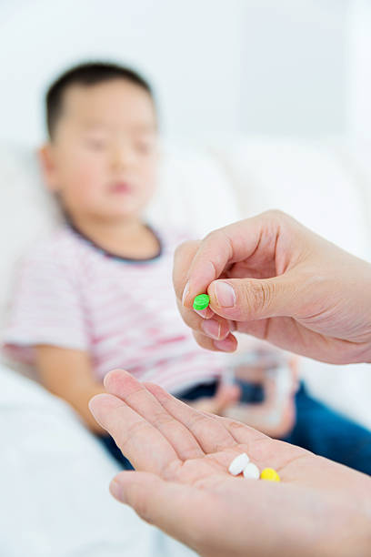 istock illness boy taking medicine 530202861