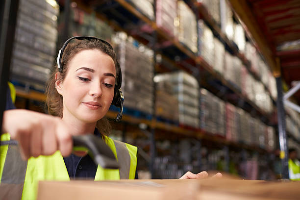 istock Woman uses barcode reader in a warehouse, head and shoulders 530202890