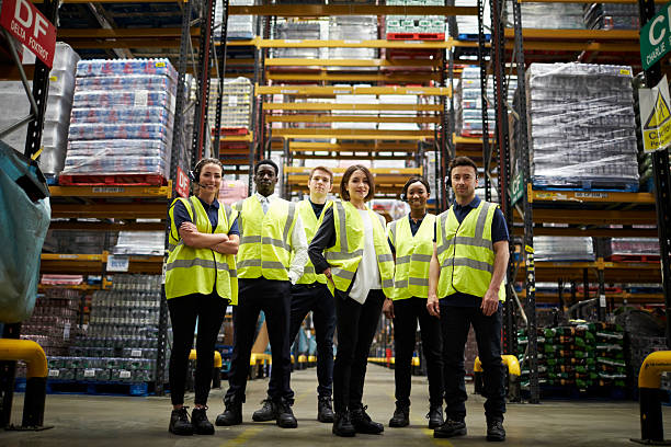 Group portrait of staff at distribution warehouse, low angle