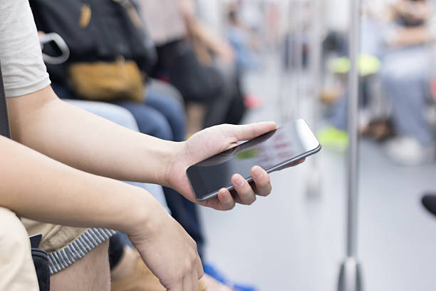 istock businessman using smart phone in subway train 530203599