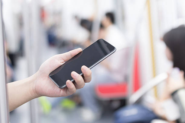 istock businessman using smart phone in subway train 530203667