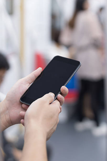 istock businessman using smart phone in subway train 530203671