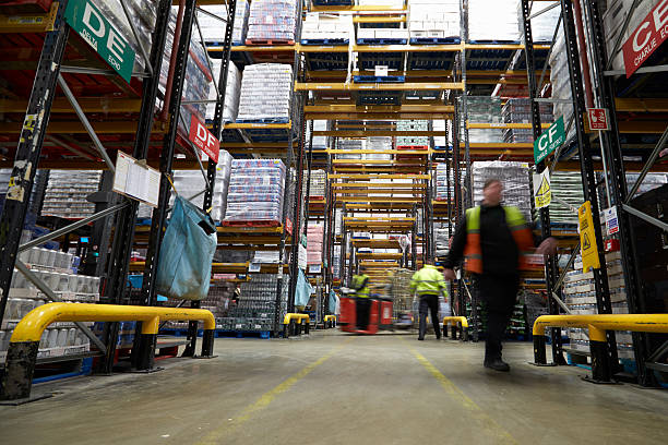 istock Staff in a warehouse move between storage racks, motion blur 530204624