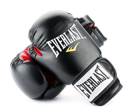 Ankara, Turkey - November 25, 2014: Everlast is an American brand manufacturing, licensing and marketing of boxing and fitness related sporting goods equipment, clothing, footwear, and accessories. Based in Manhattan, Everlast's products are sold in more than 75 countries.  A pair of black Everlast gloves isolated on white background. 
