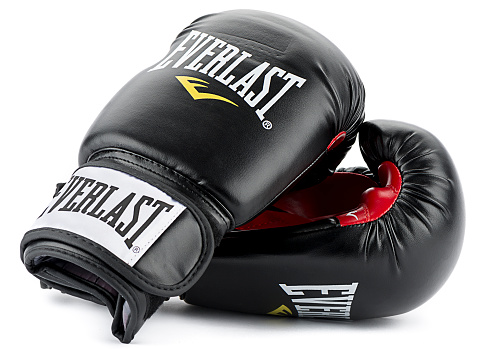 Ankara, Turkey - November 25, 2014: Everlast is an American brand manufacturing, licensing and marketing of boxing and fitness related sporting goods equipment, clothing, footwear, and accessories. Based in Manhattan, Everlast's products are sold in more than 75 countries.  A pair of black Everlast boxing gloves isolated on white background.