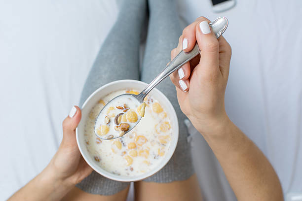 istock Woman eating cereals in bed 530205268