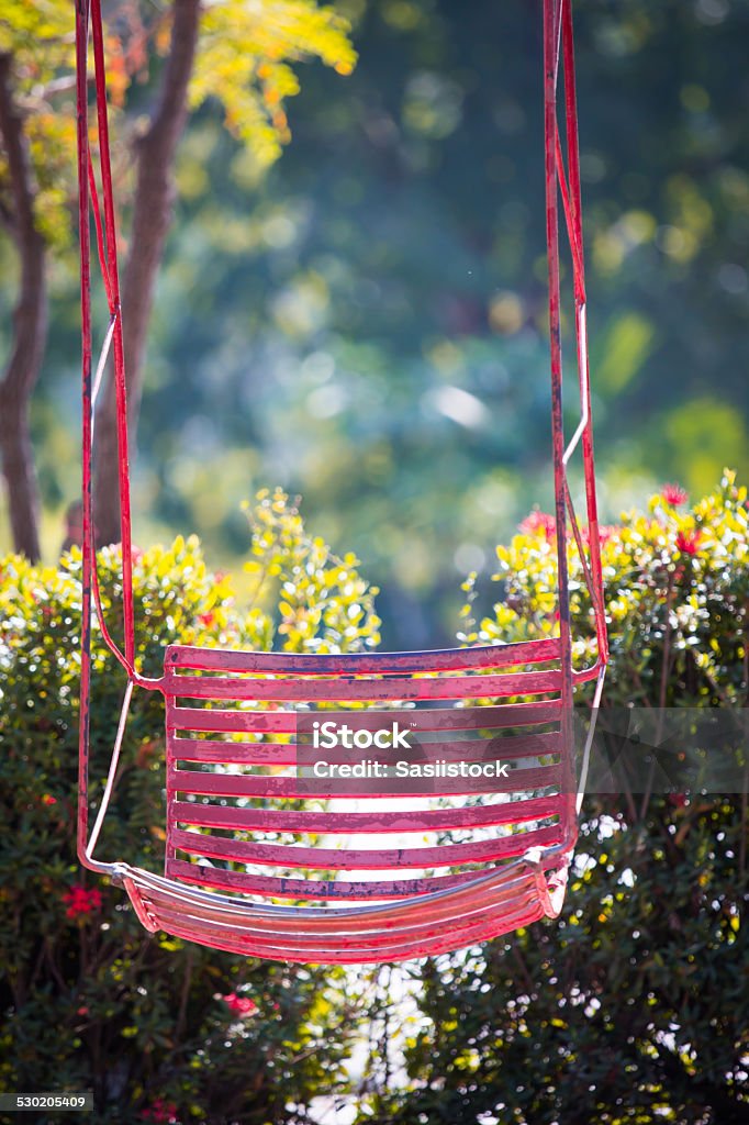 Pink old  and rusty iron swings Pink old  and rusty iron swings on playground Backgrounds Stock Photo