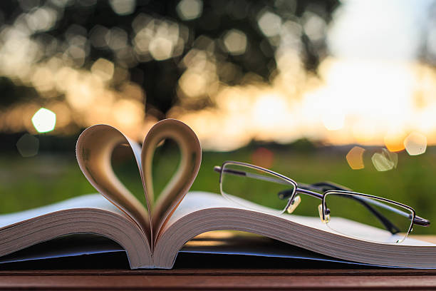 istock Close up book and glasses on table in sunset time 530206833
