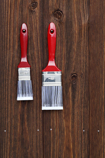 istock paint brush hung on wall 530207244