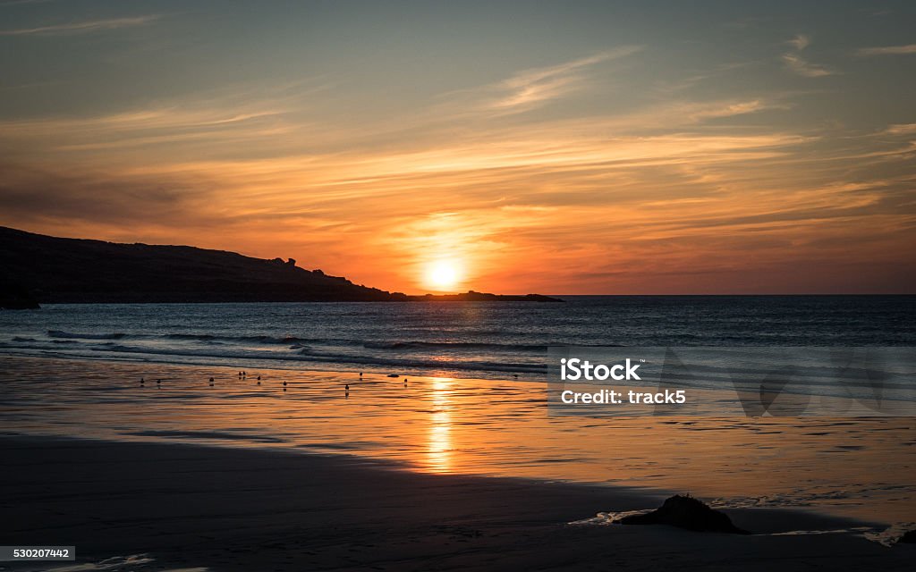 Porthmeor beach sunset, St. Ives, Cornwall, England A dusky sunset view of Porthmeor beach at the end of a spring day in the sleepy Cornish fishing village of St. Ives, England. Beach Stock Photo