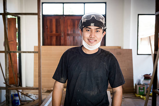istock Young male carpenter portrait in workshop interior 530208528