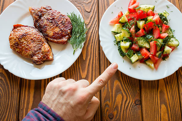 istock vegetarian chooses salad instead of fried meat 530209004