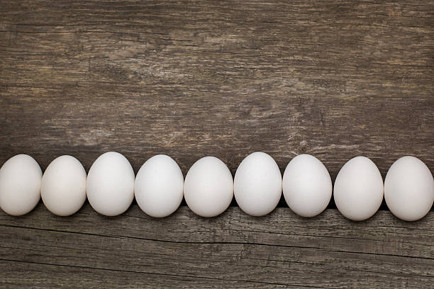 istock Chicken eggs on wooden table.  Top view and flat lay. 530209828
