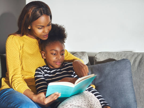 istock Mom teaching daughter to read 530210786