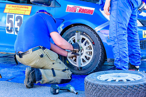 Emmaboda, Sweden - May 7, 2016: 41st South Swedish Rally in service depot. Crew checking wheel on blue Renault Clio at team Eriksson (53).