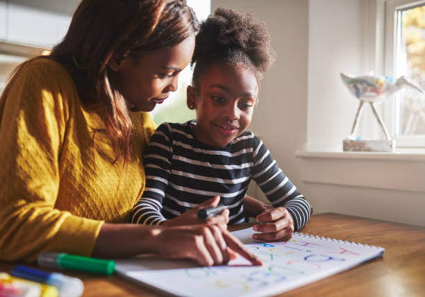 istock Black mother learning her daughter the alphabet 530211316