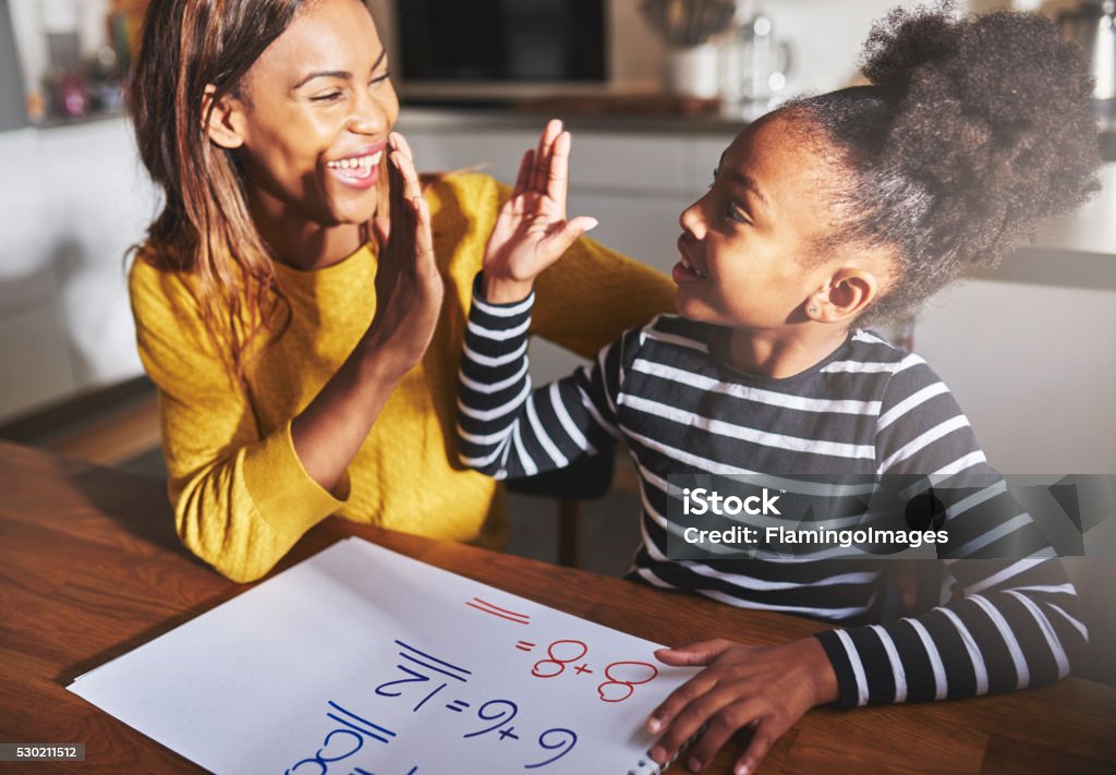 Learning to calculate, high five success Learning to calculate, high five success, black mother and child Child Stock Photo