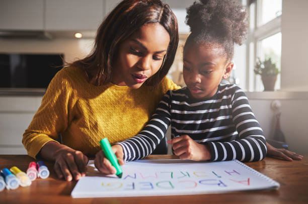 istock Black mother and child doing homework 530211788