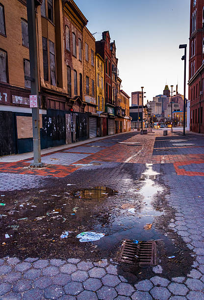 istock Puddles and abandoned shops at Old Town Mall, Baltimore, Marylan 530222593