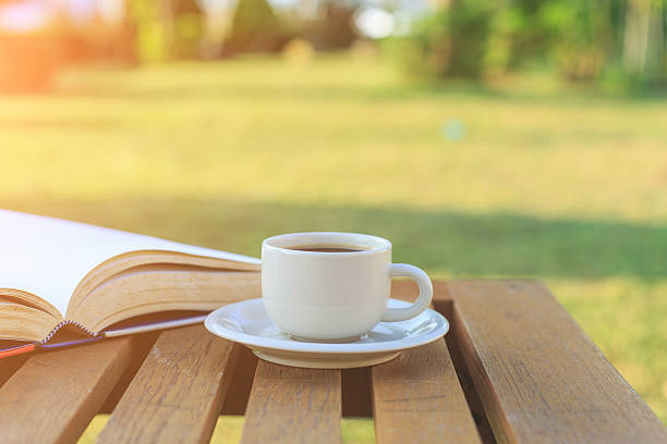 istock Coffee cup and book on the table in the morning 530224315