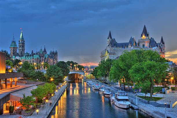 Ottawa Ontario Canada Sunset Ottawa at sunset with storm clouds advancing. Featuring Parliament Buildings, Rideau Canal a UNESCO world heritage site, Chateau Laurier Hotel, National Art Gallery and National Conference Centre. Boats docked along Rideau Canal. chateau laurier stock pictures, royalty-free photos & images