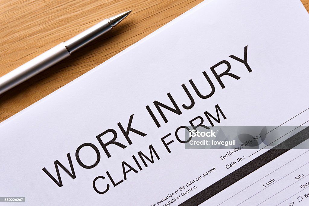 work injury claim form on the table Application Form Stock Photo