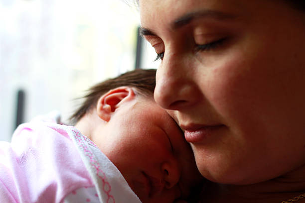 istock baby sleeping on mother's shoulder. 530226789