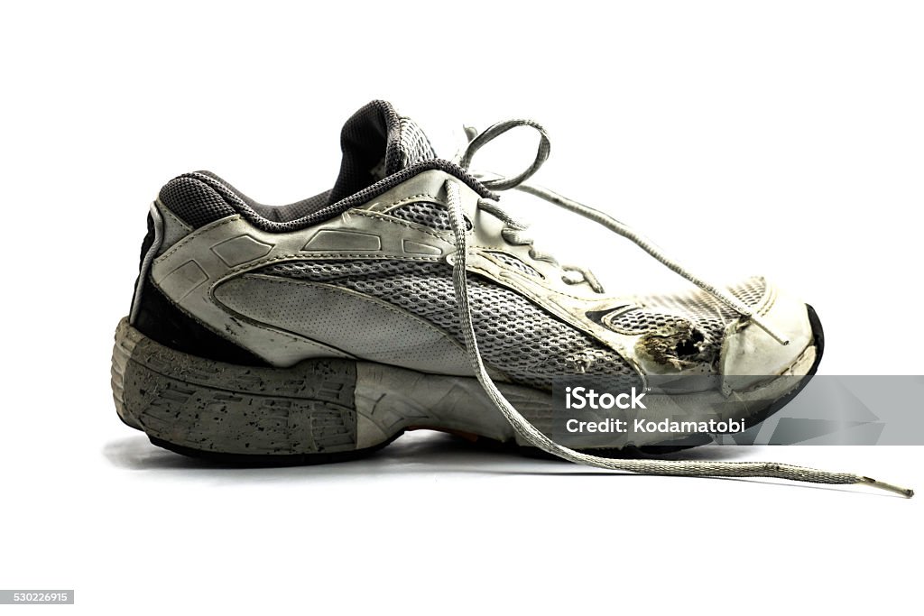 Old running shoes Worn old running shoes on white background Active Lifestyle Stock Photo