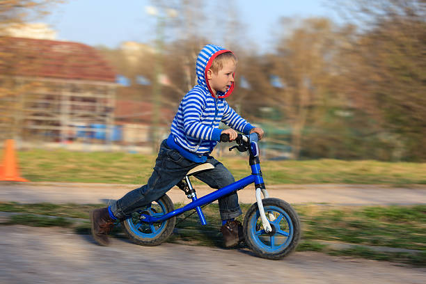 istock little boy riding runbike 530227595