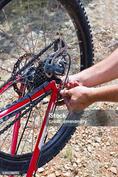 Man Repairing A Bike Stock Photo - Download Image Now - Assistance, Backgrounds, Bicycle