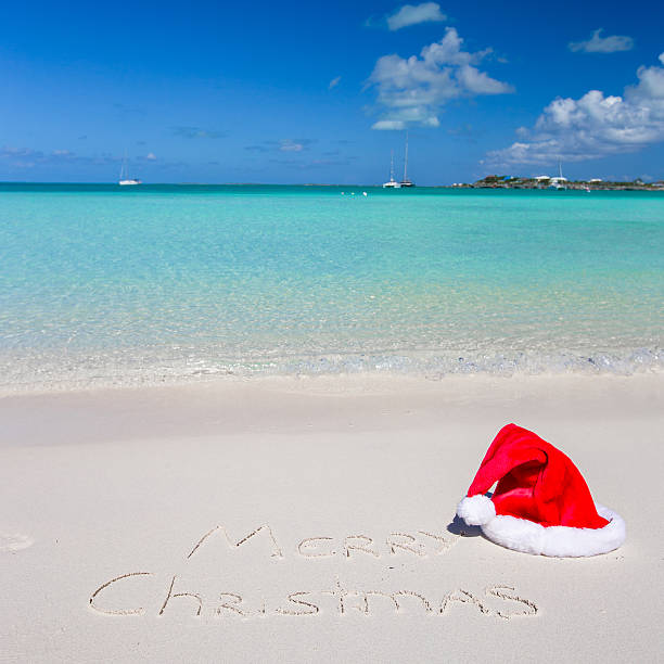 istock Merry Christmas written on tropical beach white sand 530229071