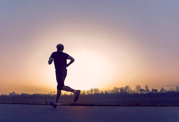 istock Running man silhouette in sunset time 530234335