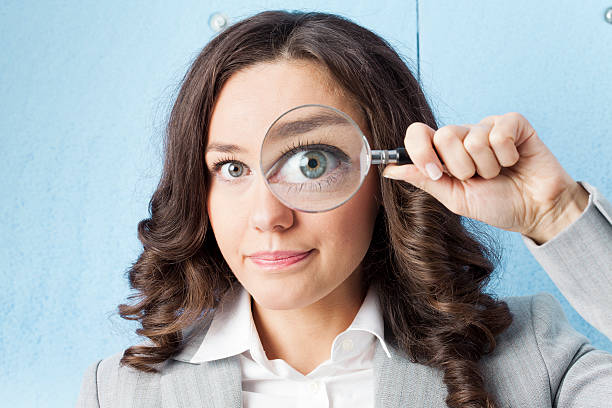 istock Woman with magnifying glass 530234997