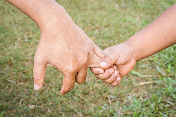 istock Father holding a hand of his son. 530236371