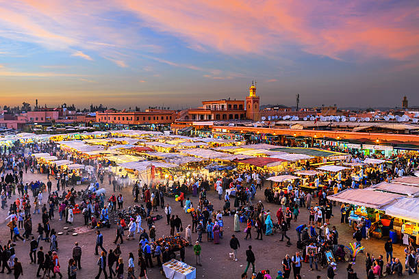 Evening Djemaa El Fna Square with Koutoubia Mosque, Marrakech, Morocco Famous Djemaa El Fna Square in early evening light, Marrakech, Morocco with the Koutoubia Mosque, Northern Africa.Nikon D3x marrakesh photos stock pictures, royalty-free photos & images
