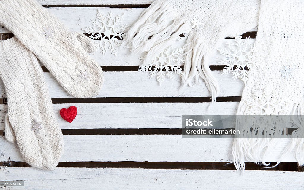 white mittens and scarf on a wooden plank background white mittens and scarf on the wooden table Arts Culture and Entertainment Stock Photo