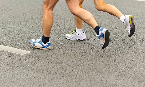istock marathon runner athletes  running on city road 530239431